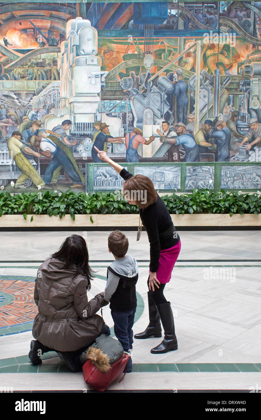 Detroit, Michigan - A docent tells visitors about Diego Rivera's 'Detroit Industry' murals at the Detroit Institute of Arts. Stock Photo