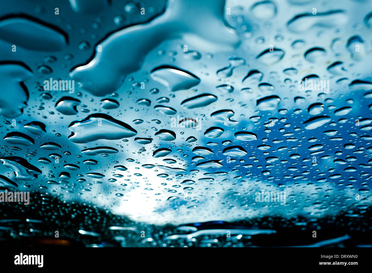 Rain lies on the surface of a glass table after storm Stock Photo