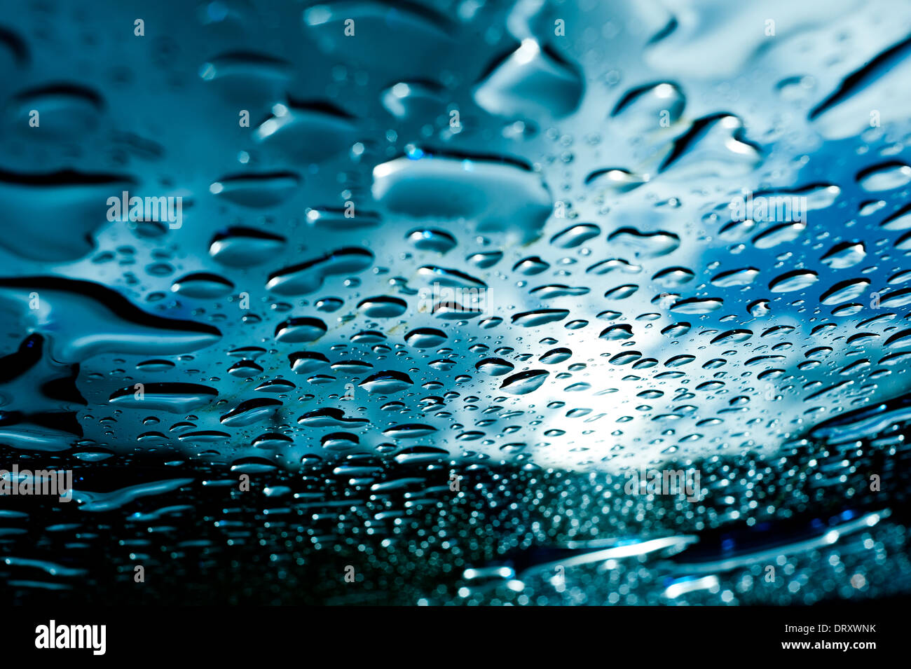 Rain lies on the surface of a glass table after storm Stock Photo