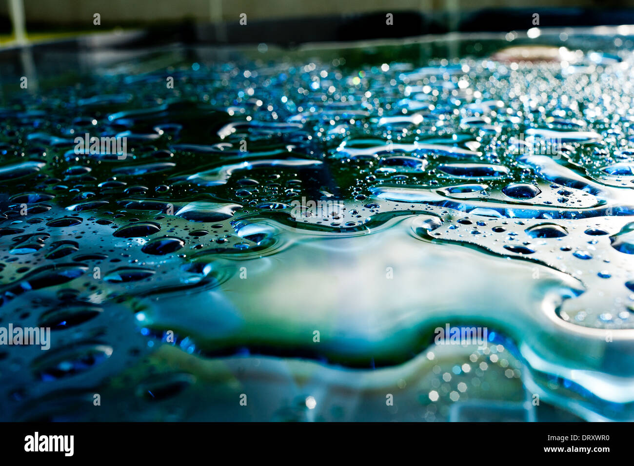 Rain lies on the surface of a glass table after storm Stock Photo