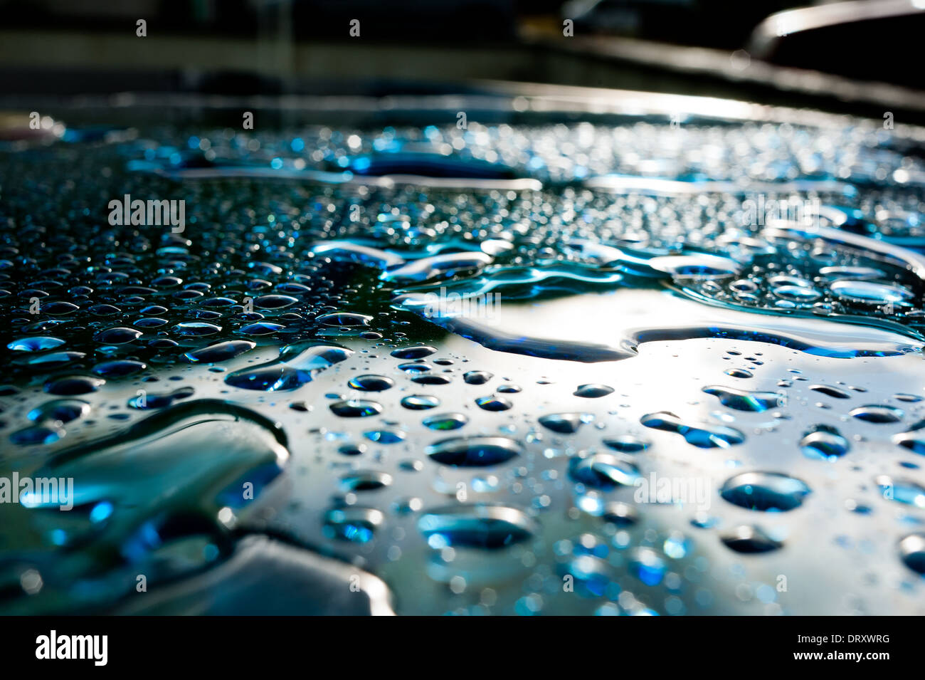 Rain lies on the surface of a glass table after storm Stock Photo