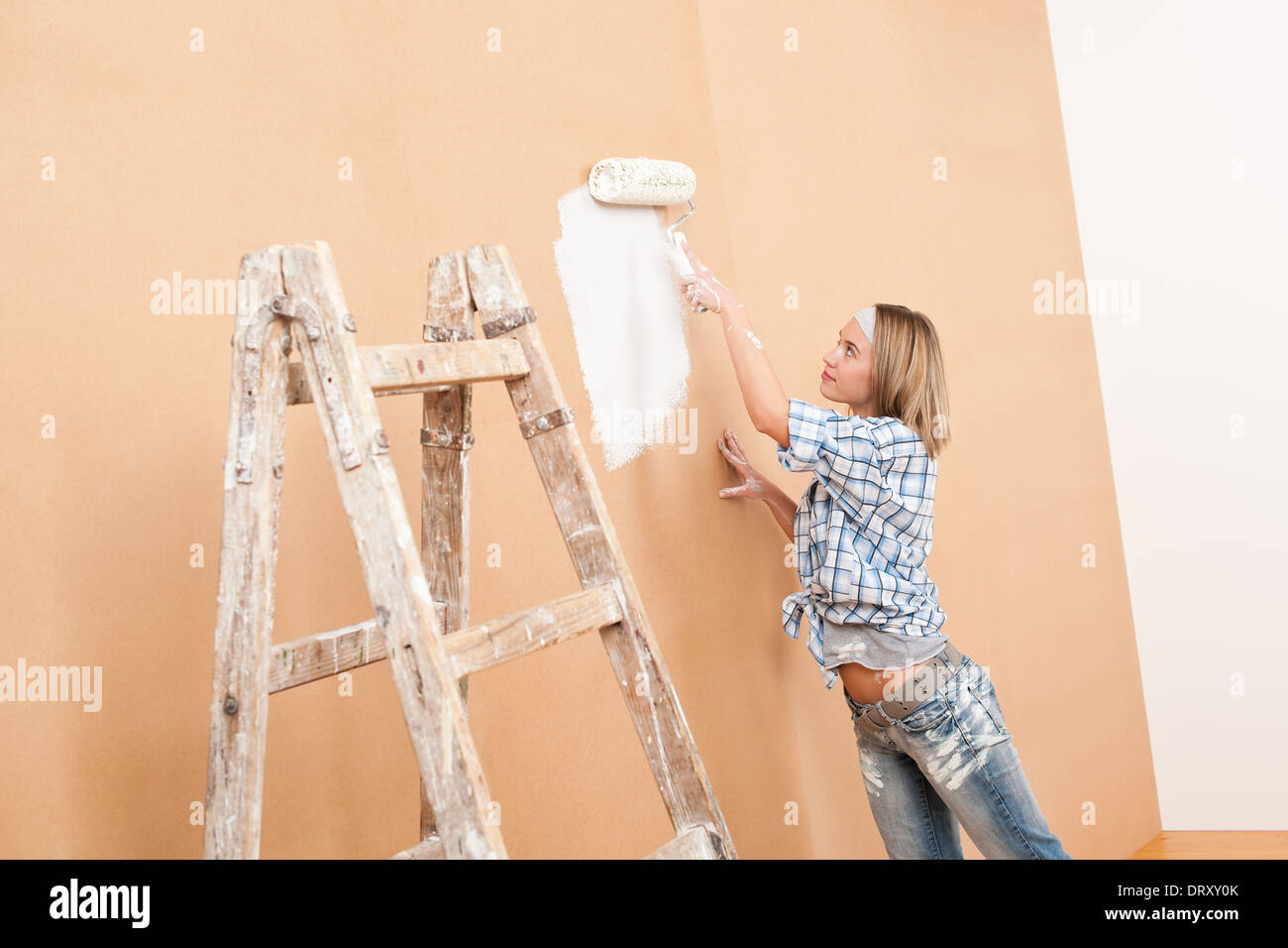 Home improvement Woman painting wall Stock Photo Alamy