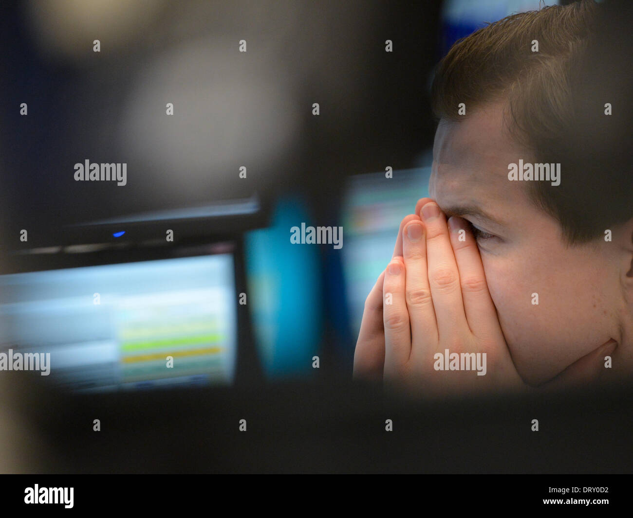 Frankfurt Main, Germany. 04th Feb, 2014. A floor trader covers his face with his hands at the stock market in Frankfurt Main, Germany, 04 February 2014. Germany's Dax index dropped after a sharp fall in prices in Asia. Photo: Arne Dedert/dpa/Alamy Live News Stock Photo