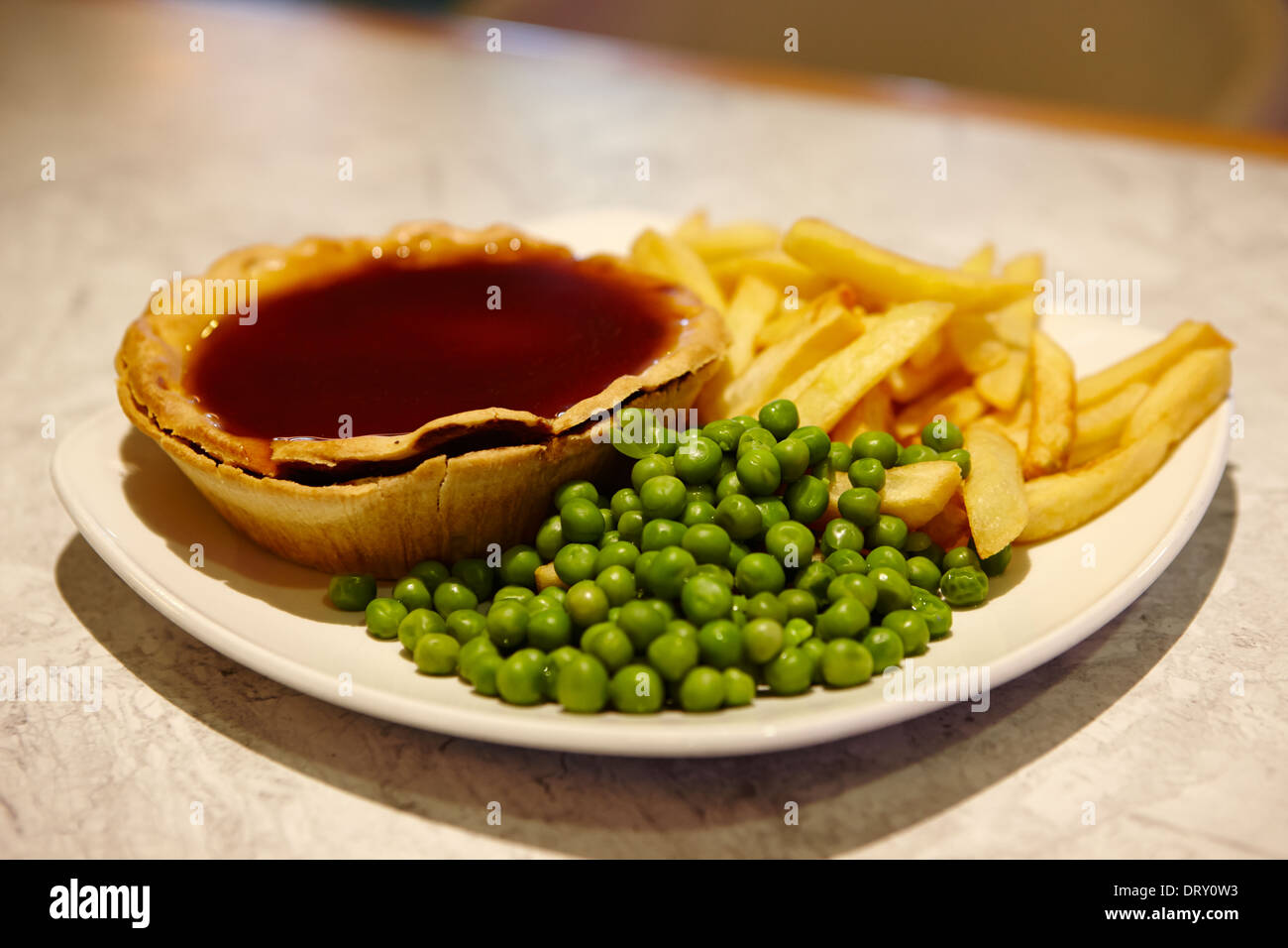 pie and gravy chips and peas Stock Photo