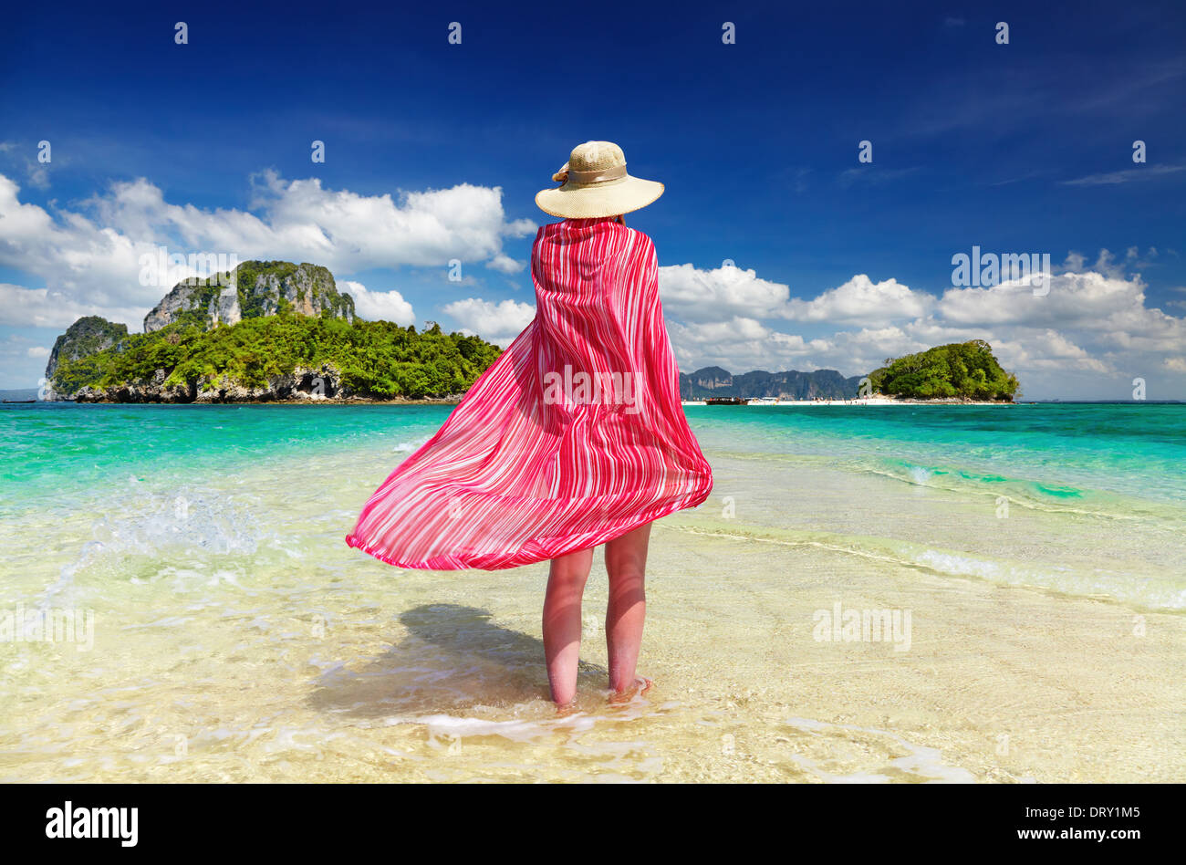 Woman in pink pareo and hat at the beach, Andaman Sea, Thailand Stock Photo