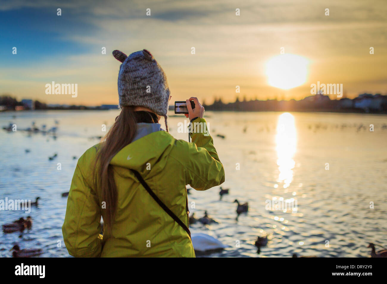 Watching the winter sunset at The Pond in Reykjavik, Iceland Stock Photo