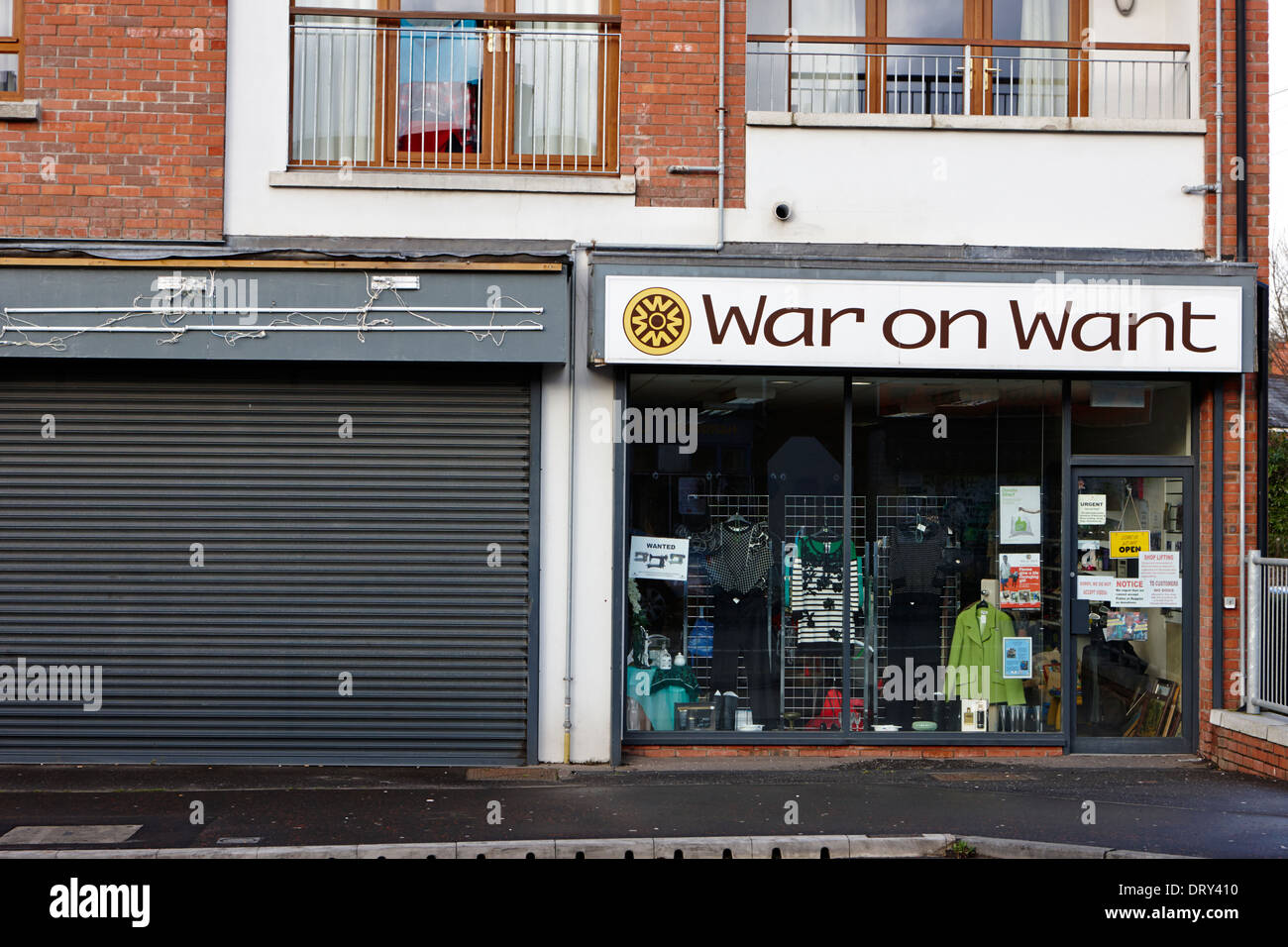 war on want charity shop next to closed shop on high street dunmurry belfast uk Stock Photo