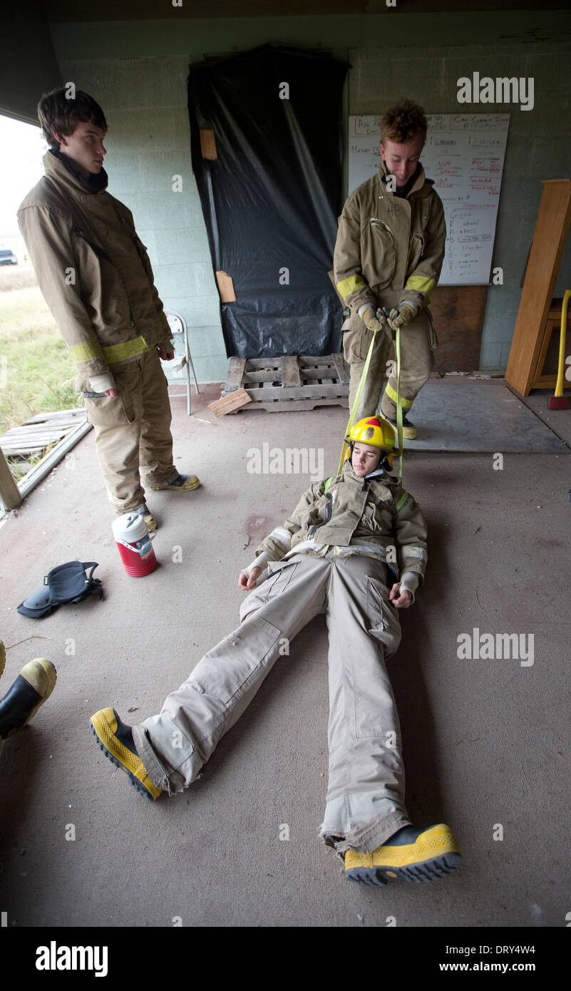 Student trainee practices pulling classmate with harness across floor ...