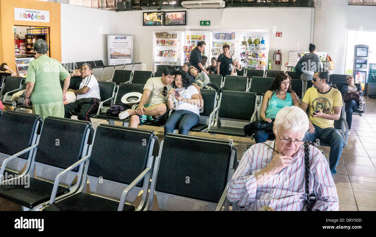 airline passengers in new departure lounge Huatulco airport for travel from lower Pacific coast to US Canada & within Mexico Stock Photo