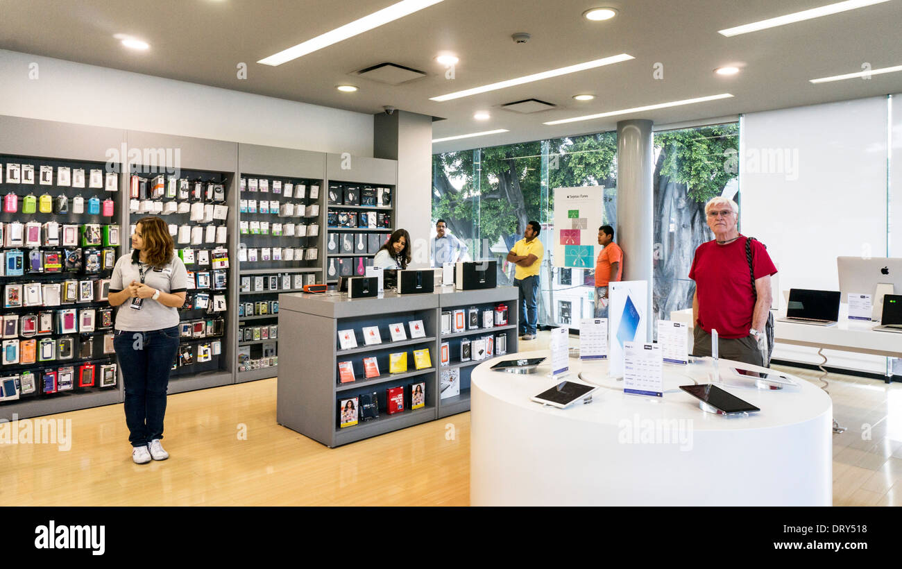 elegant white cubist interior display & sales area of Apple ishop store in affluent upscale  Colonia Reforma district Oaxaca Stock Photo