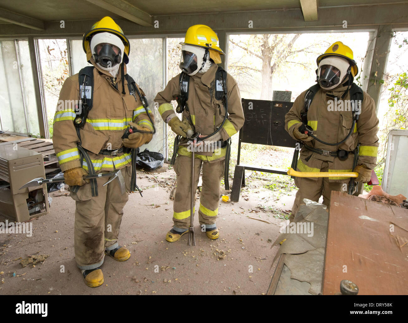High school fire academy students  wait their turn to crawl through smoke-filled house during training exercise Stock Photo