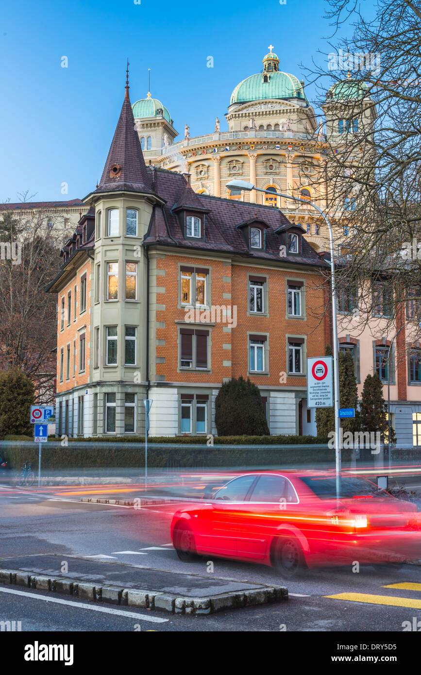 Red car is on the Bern street with city hall at background Stock Photo
