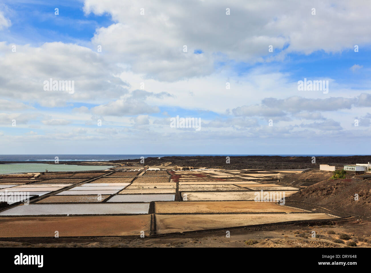 Salt pans of Canary Island's most important saltmine Salinas de Janubio producing sea salt on west coast of Lanzarote Spain Stock Photo