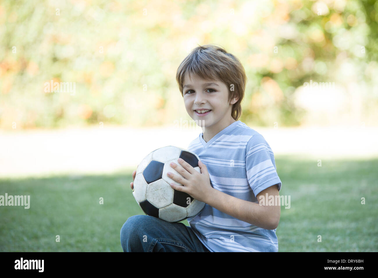 Boy holding soccer ball, portrait Stock Photo