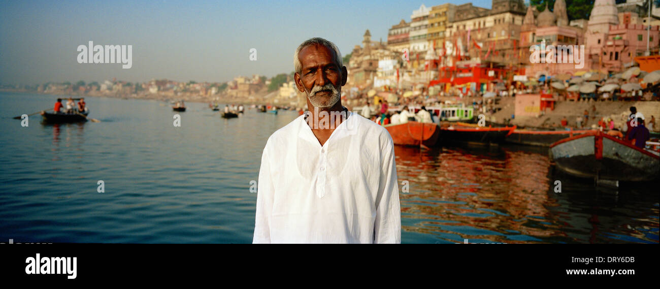 Boat man looking into lens of camera on the River Ganges, Varanasi, India, Asia Stock Photo