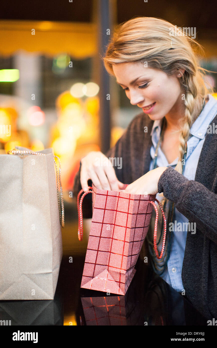 Satisfied shopper examining her purchases Stock Photo