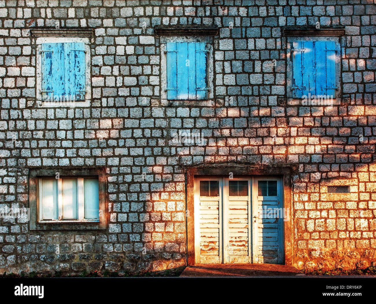 Old stones wall with door and windows Stock Photo - Alamy