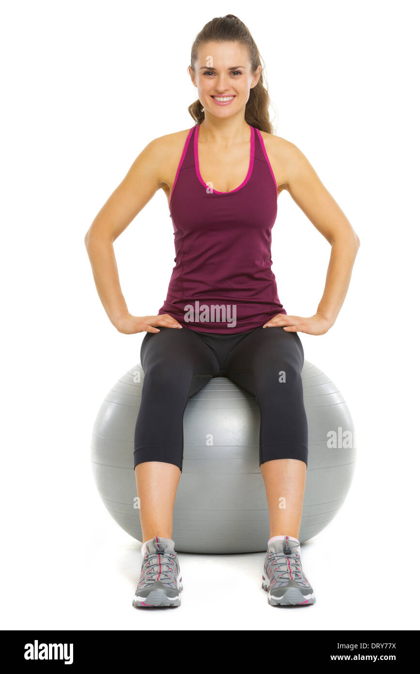 Smiling fitness young woman sitting on fitness ball Stock Photo - Alamy