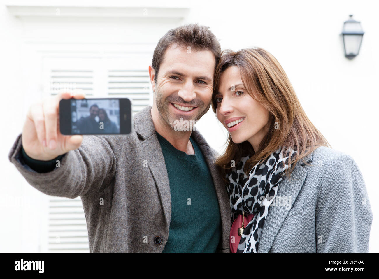 Couple taking self portrait with camera phone Stock Photo