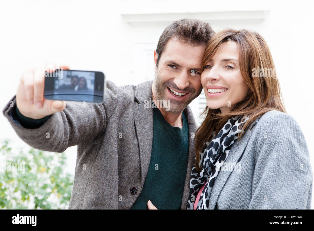 Couple taking self portrait with camera phone Stock Photo