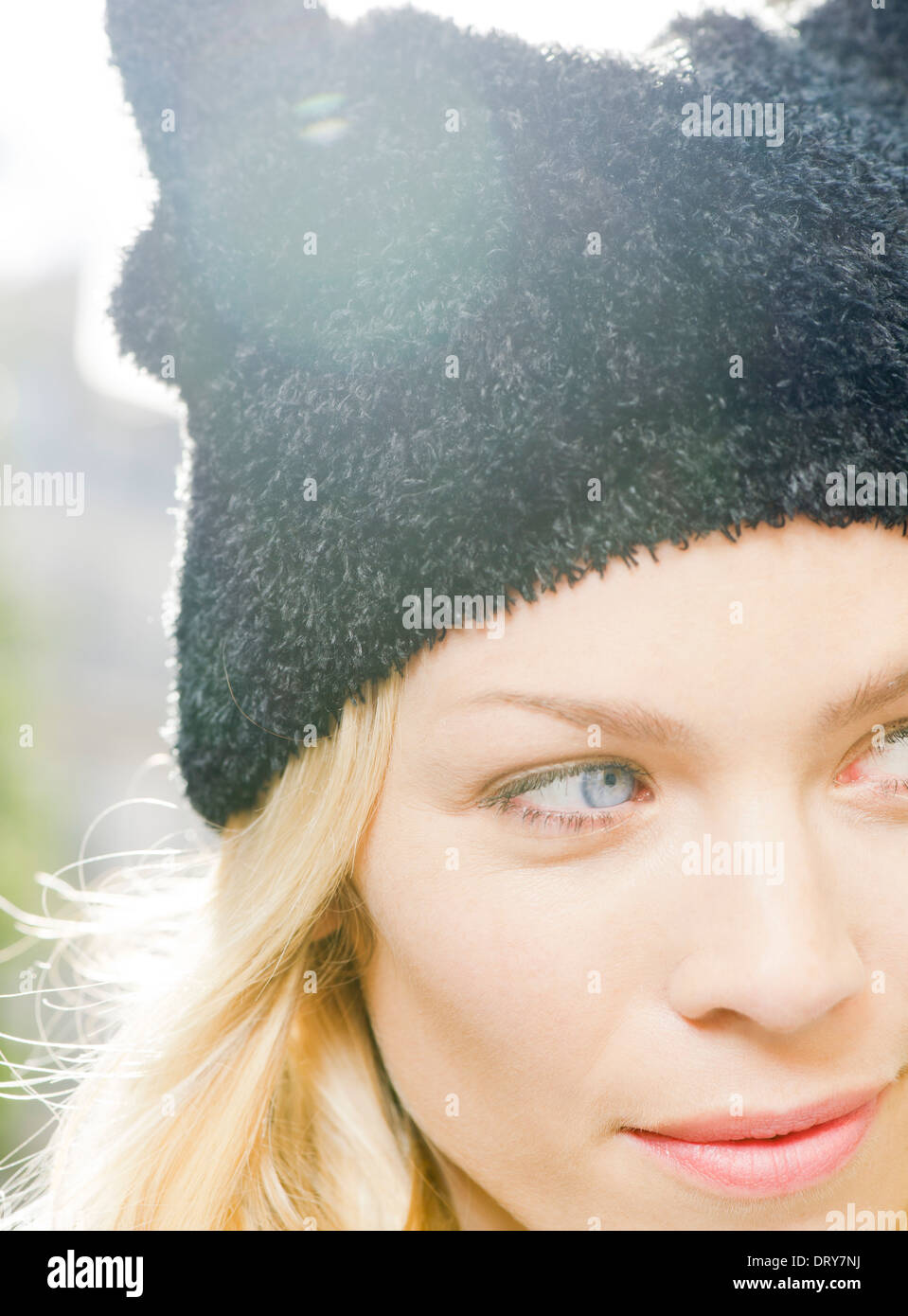 Woman wearing knit hat, looking away in thought, portrait Stock Photo