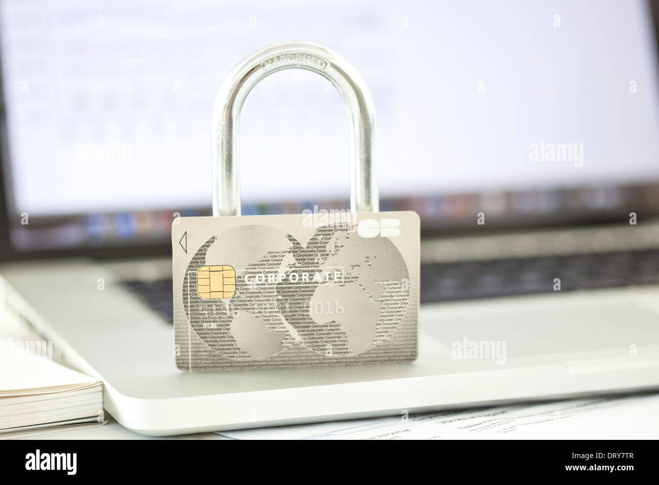 Credit card and lock resting on top of laptop computer representing internet security Stock Photo