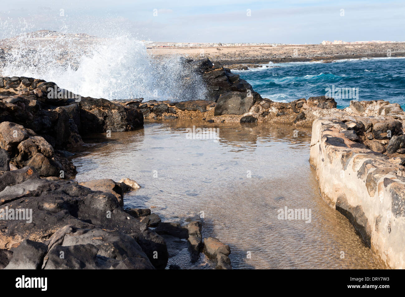 Sea foam at high tide breaking over into the blow hole collecting basin at the Museum of Salt (Museo de la Sal), Fuerteventura Stock Photo