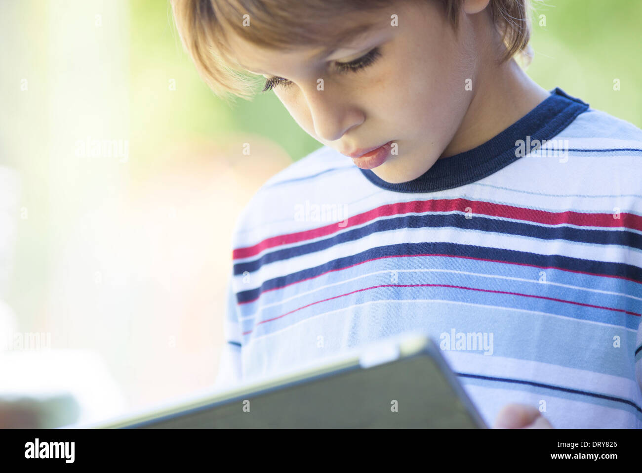 Boy using digital tablet Stock Photo