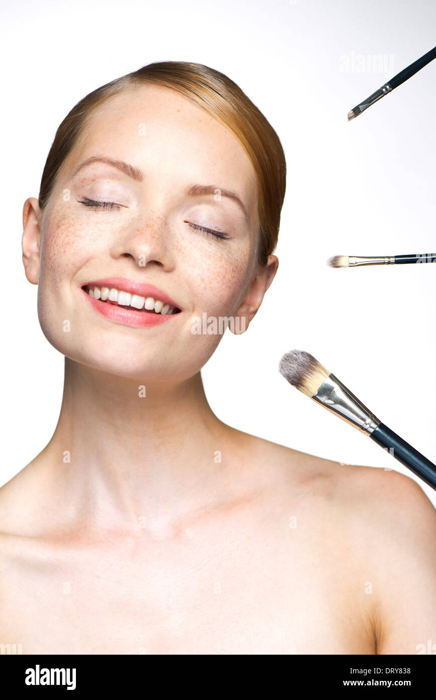 Young woman with make-up brushes Stock Photo