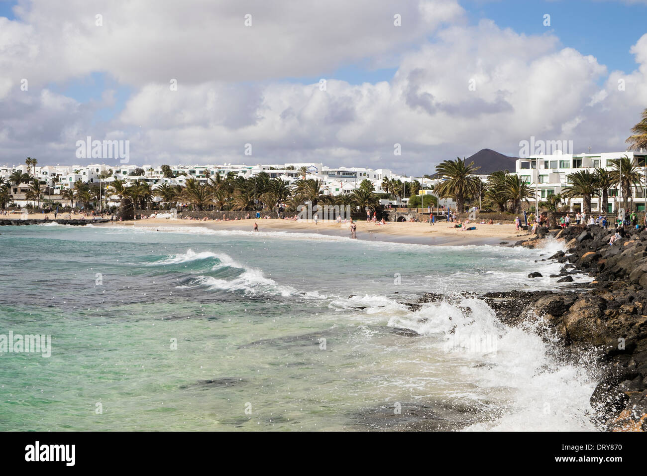 View along rocky seashore to sandy Playa de las Cucharas beach in Costa Teguise, Lanzarote, Canary Islands, Spain Stock Photo