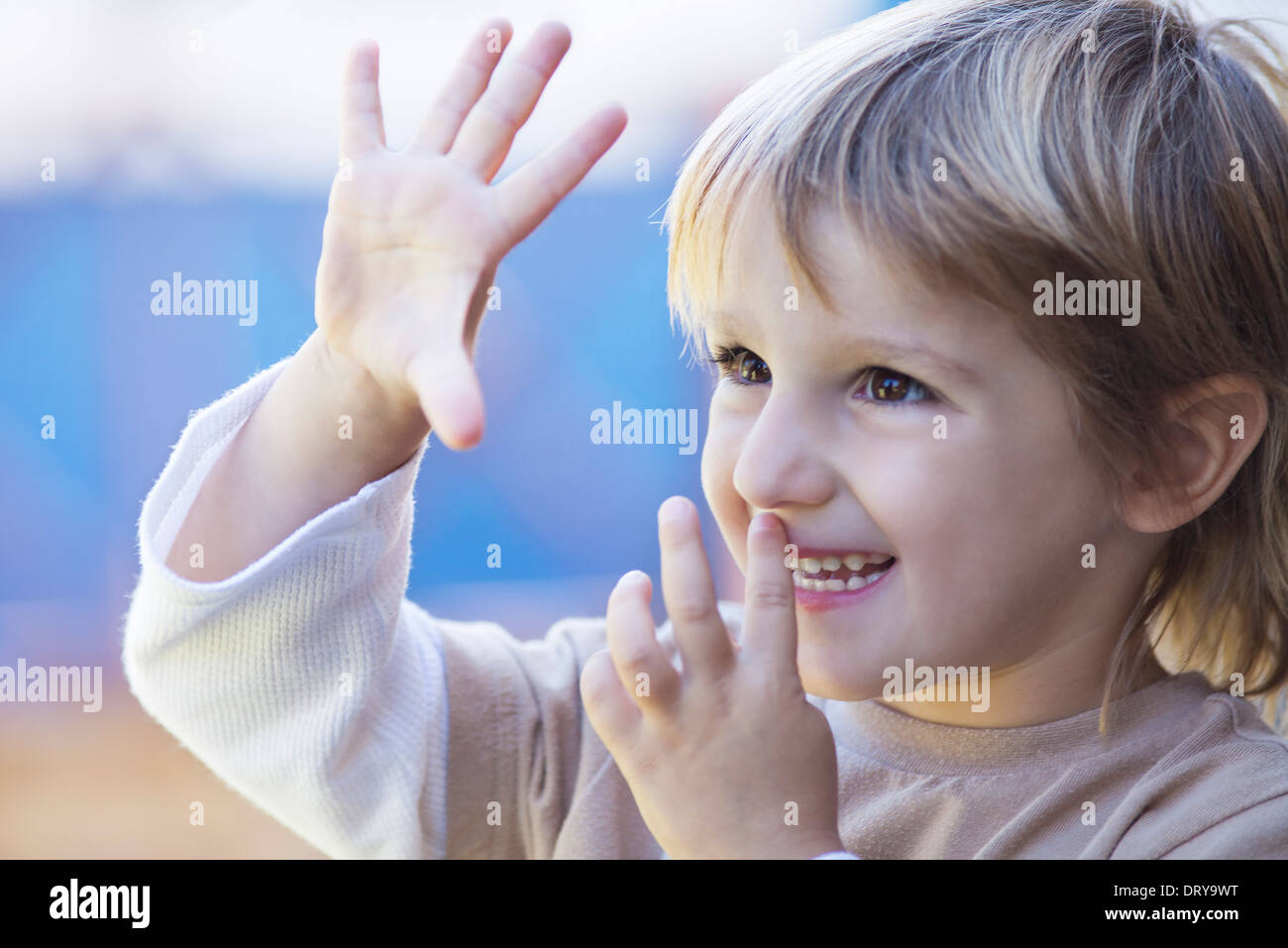 Child holding out five fingers Stock Photo