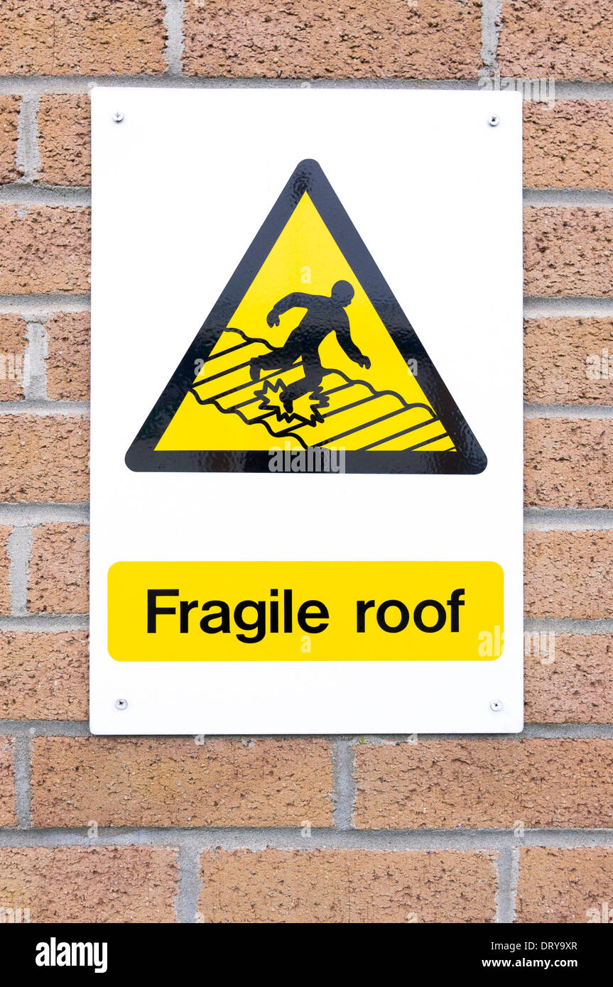 Fragile roof warning sign attached to brick wall Stock Photo Alamy