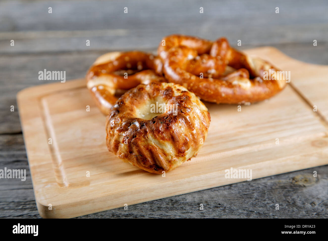 Soft newly-baked rolls on an old kitchen table Stock Photo
