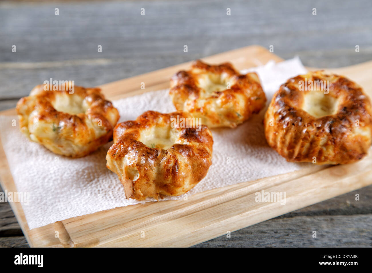 Soft newly-baked rolls on an old kitchen table Stock Photo