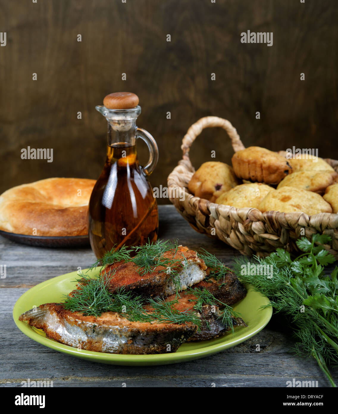 Fried fish with greens and olive oil Stock Photo Alamy