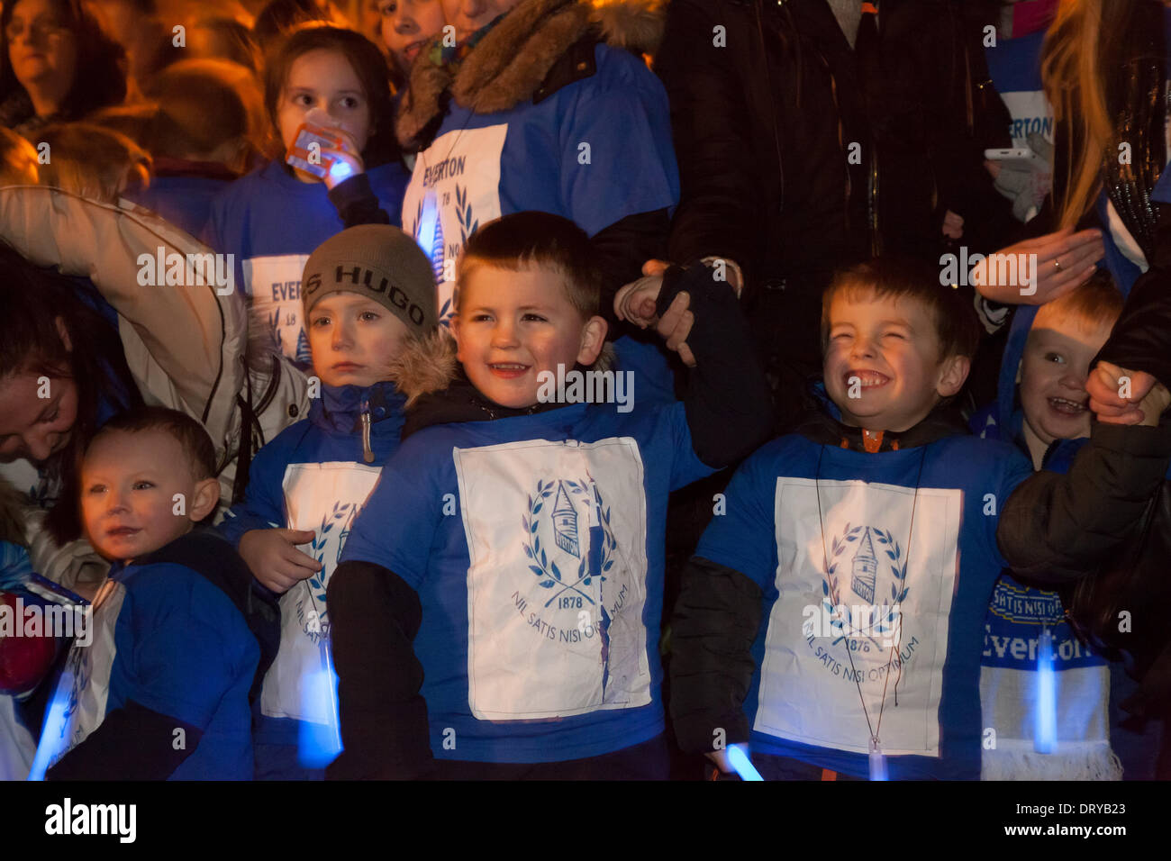 Liverpool, UK. 4th February 2014. A group of school children from Everton wait for Everton manager Roberto Martinez to arrive. Martinez was in Browside Gardens to switch on a projection of Everton FC's crest. Credit:  Adam Vaughan/Alamy Live News Stock Photo