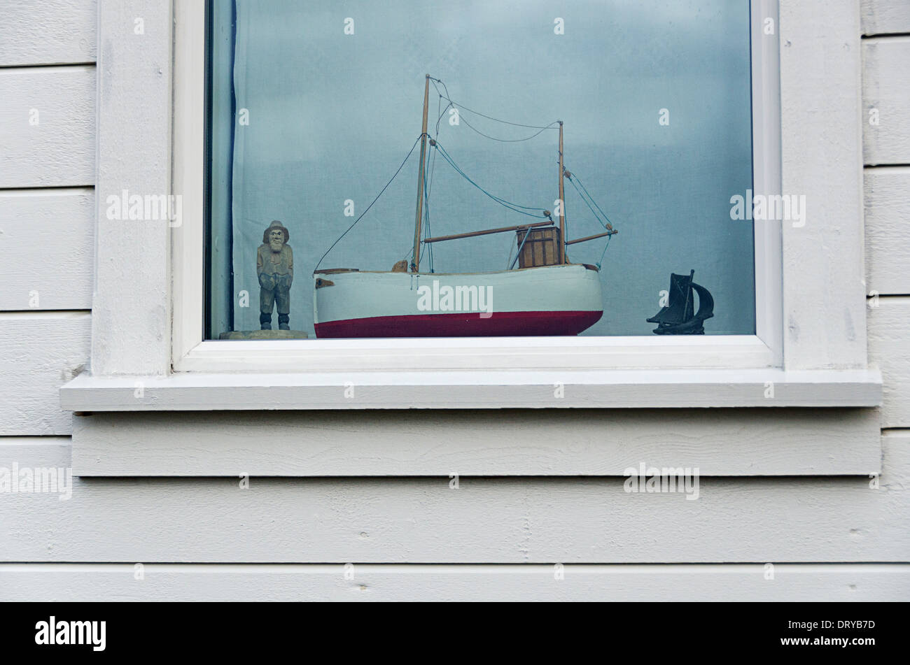 old fisherman with his boat in a window Stock Photo
