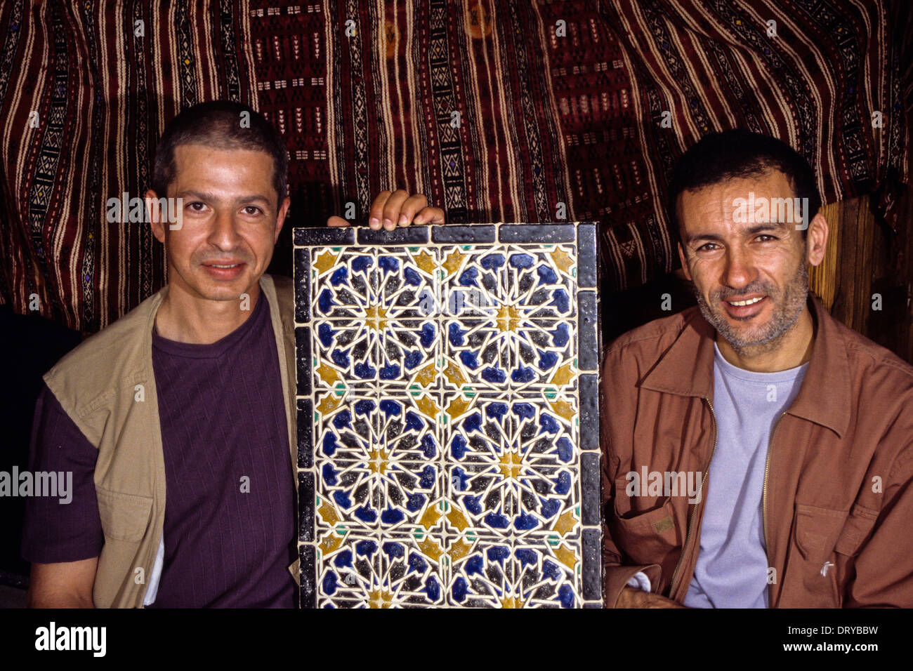 Ceramics, Nabeul, Tunisia. Patrick Cali (left) and Mohamed Messaoudi (right) showing their new resin tiles, faux-antiques. Stock Photo