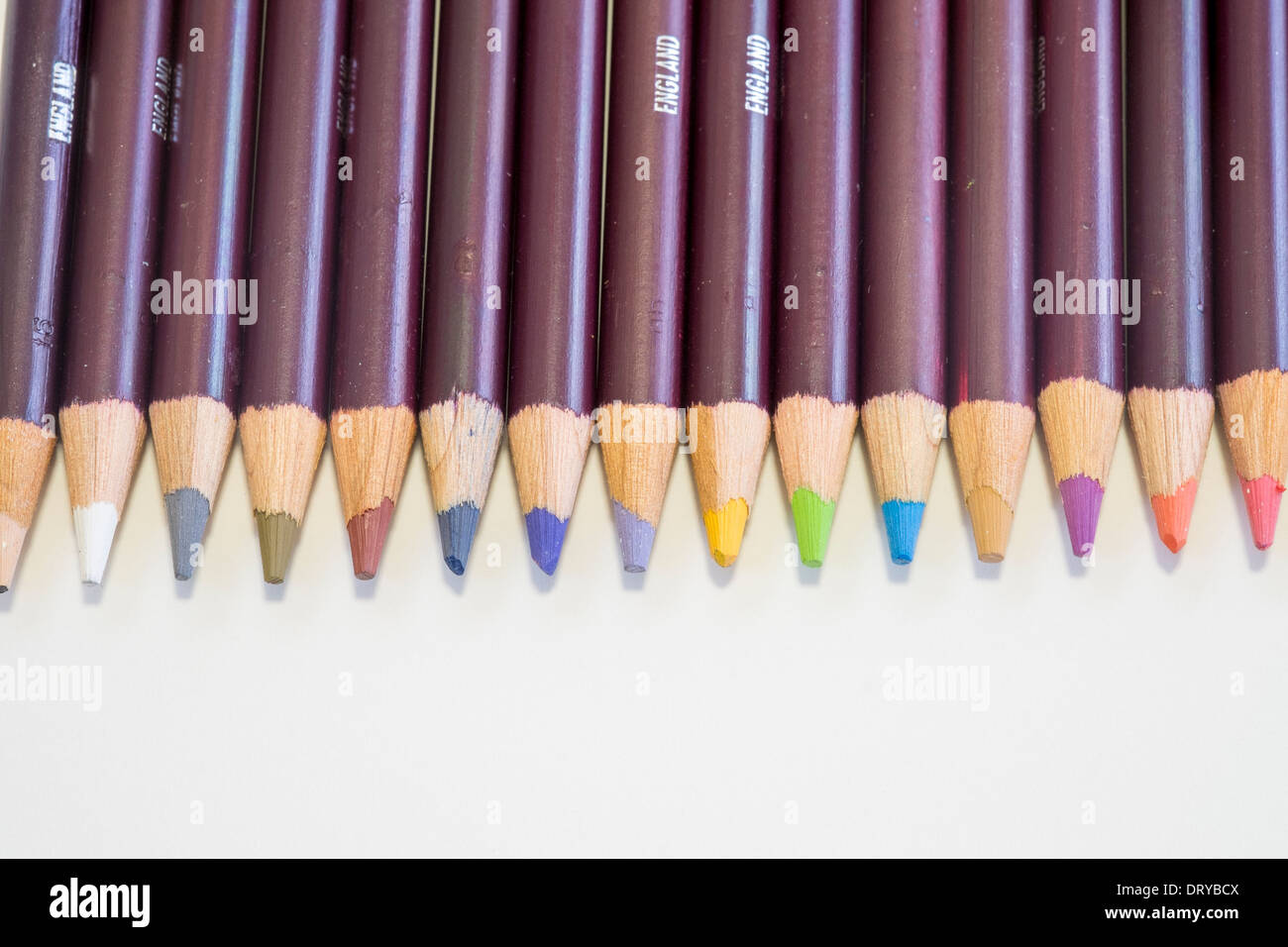 Row of coloured pencil crayon tips on white background Stock Photo