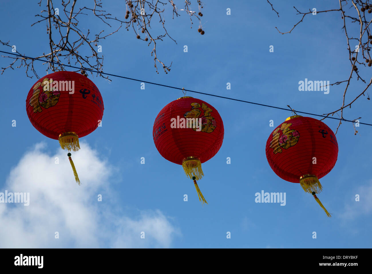 Three red Chinese lanterns against a vivid blue sky Celebrating Chinese