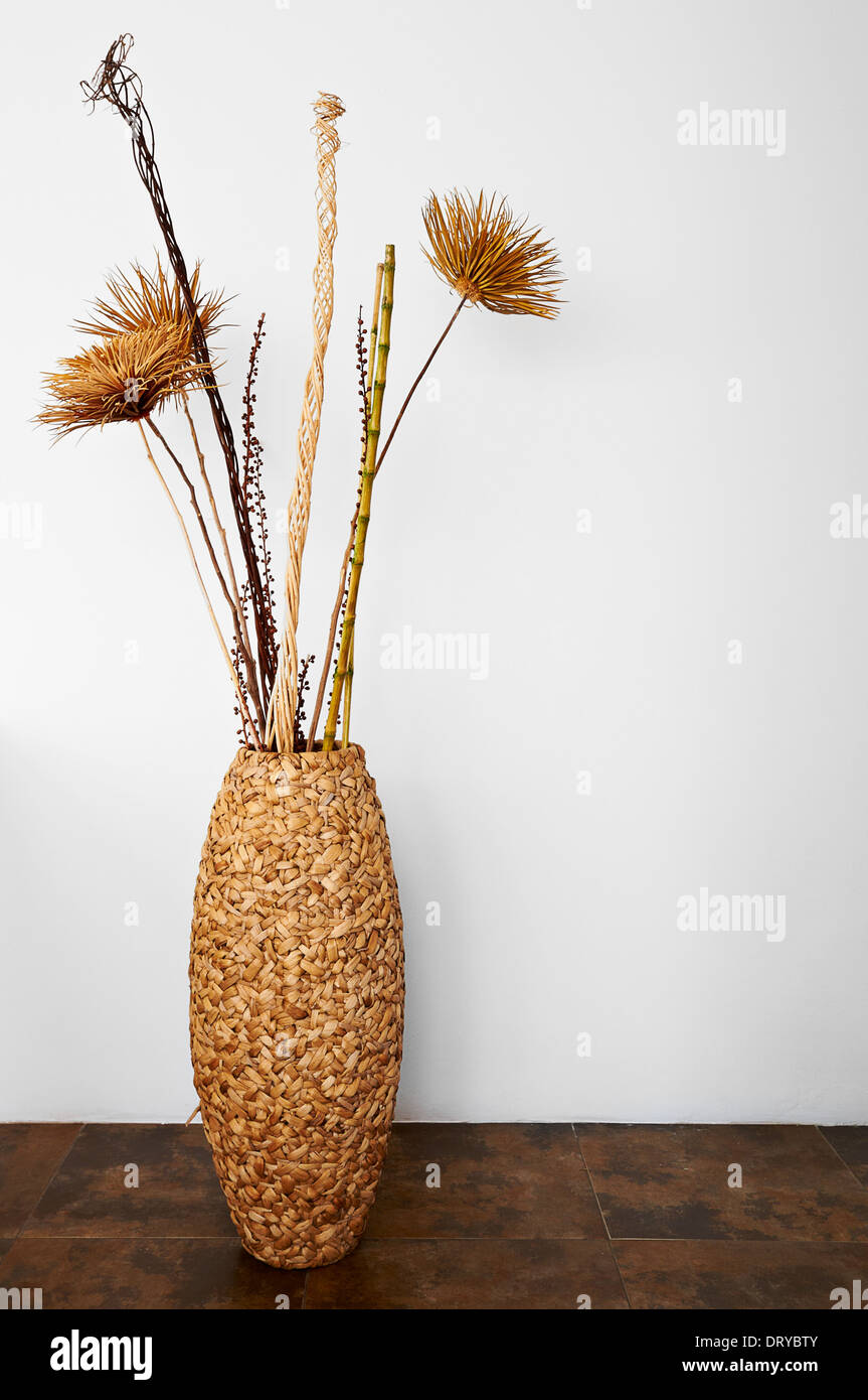 Decoration wicker vessel with dry plants Stock Photo - Alamy