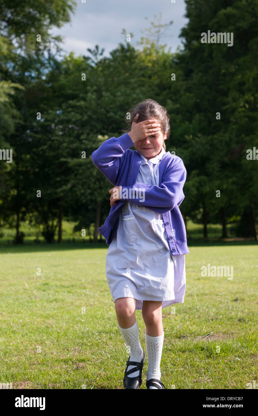 Young schoolgirl crying on her way home Stock Photo