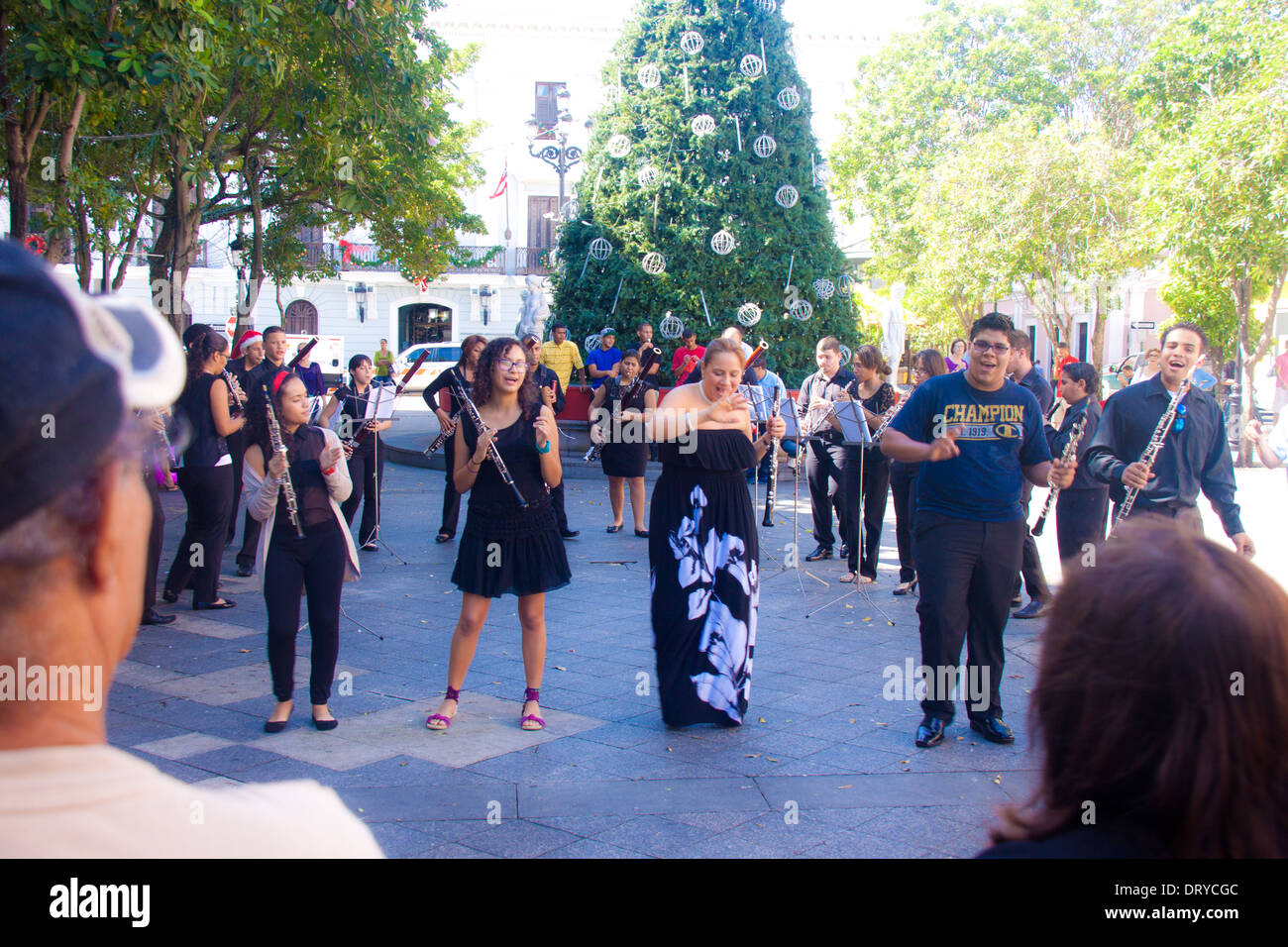 Musical group, consisting of oboes, bassoons, and clarinets, singing 'Feliz Navidad' in the public plaza, Plaza de Armas, in Old Stock Photo