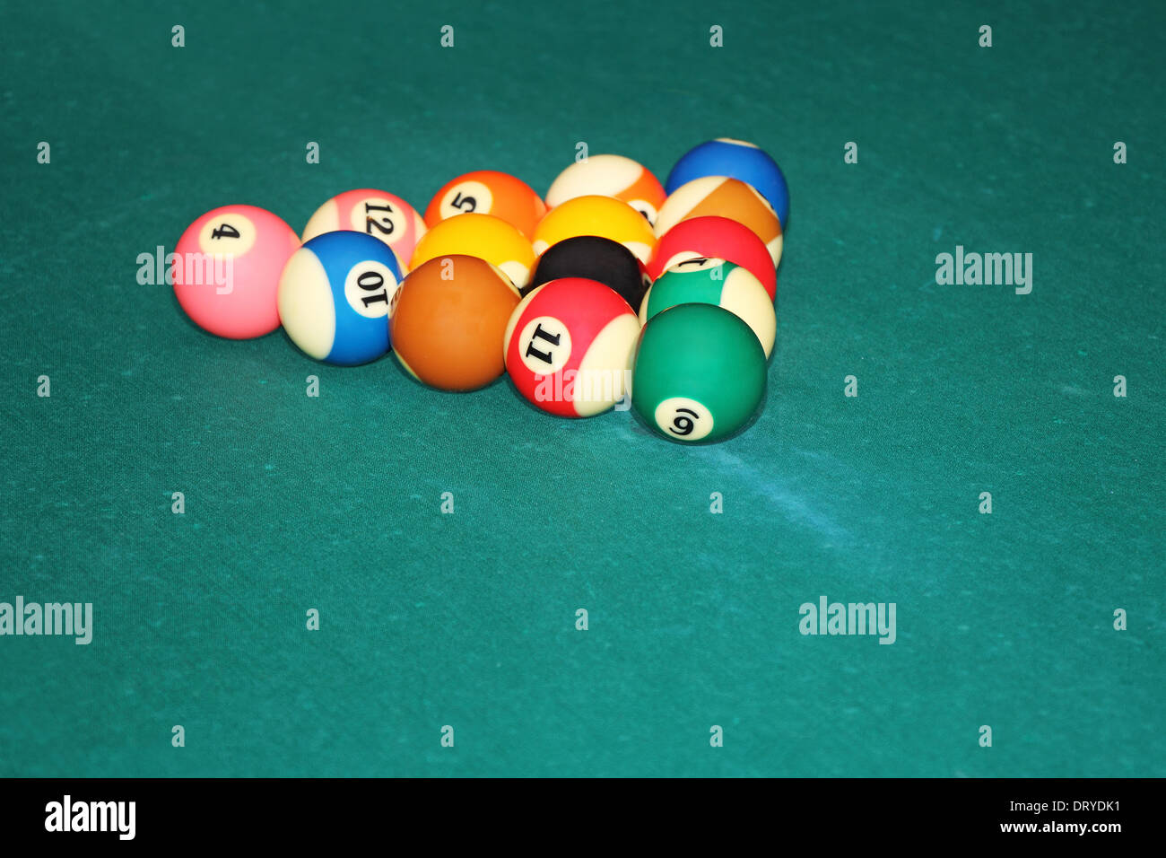 Billiards balls in triangle on the green cloth table Stock Photo