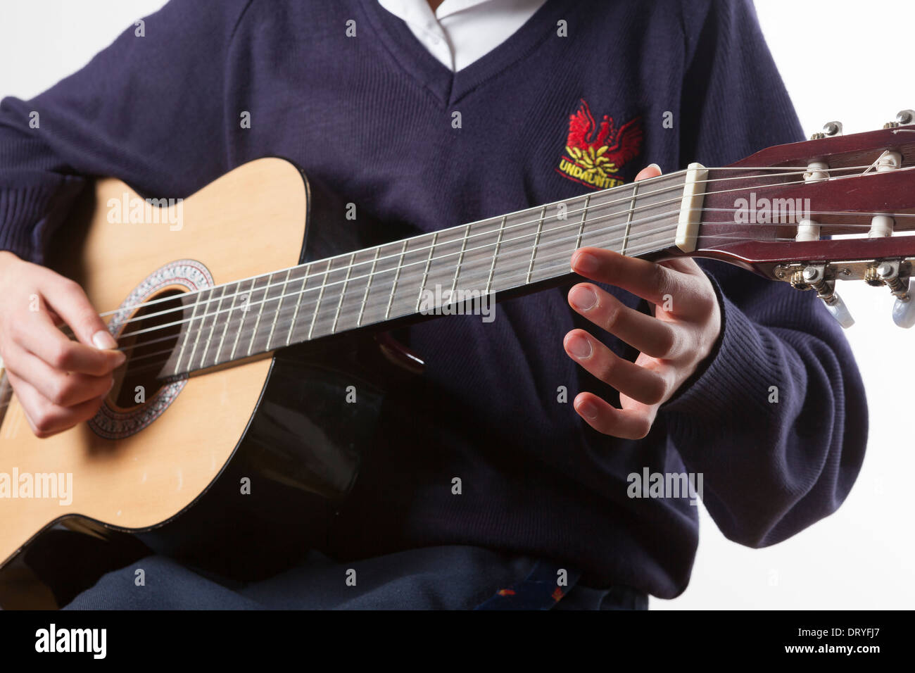 Teenage schoolgirl plays guitar Stock Photo
