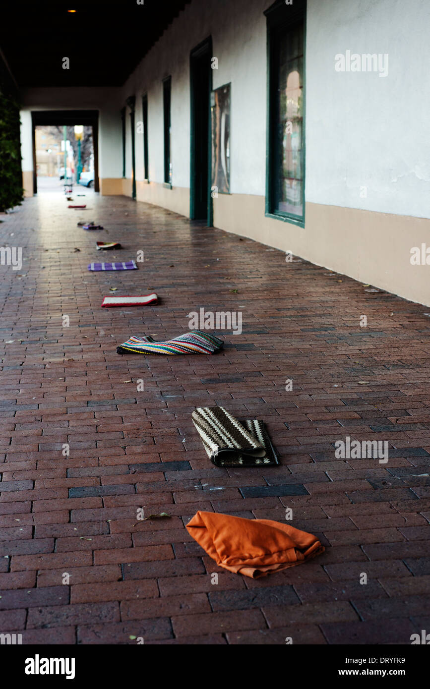 Indigenous Indian traders mark their spot at the start of the day in front of the Governor's Mansion by placing rugs. Stock Photo