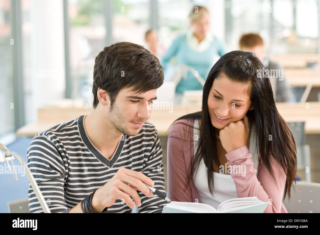 Two students read book in classroom Stock Photo