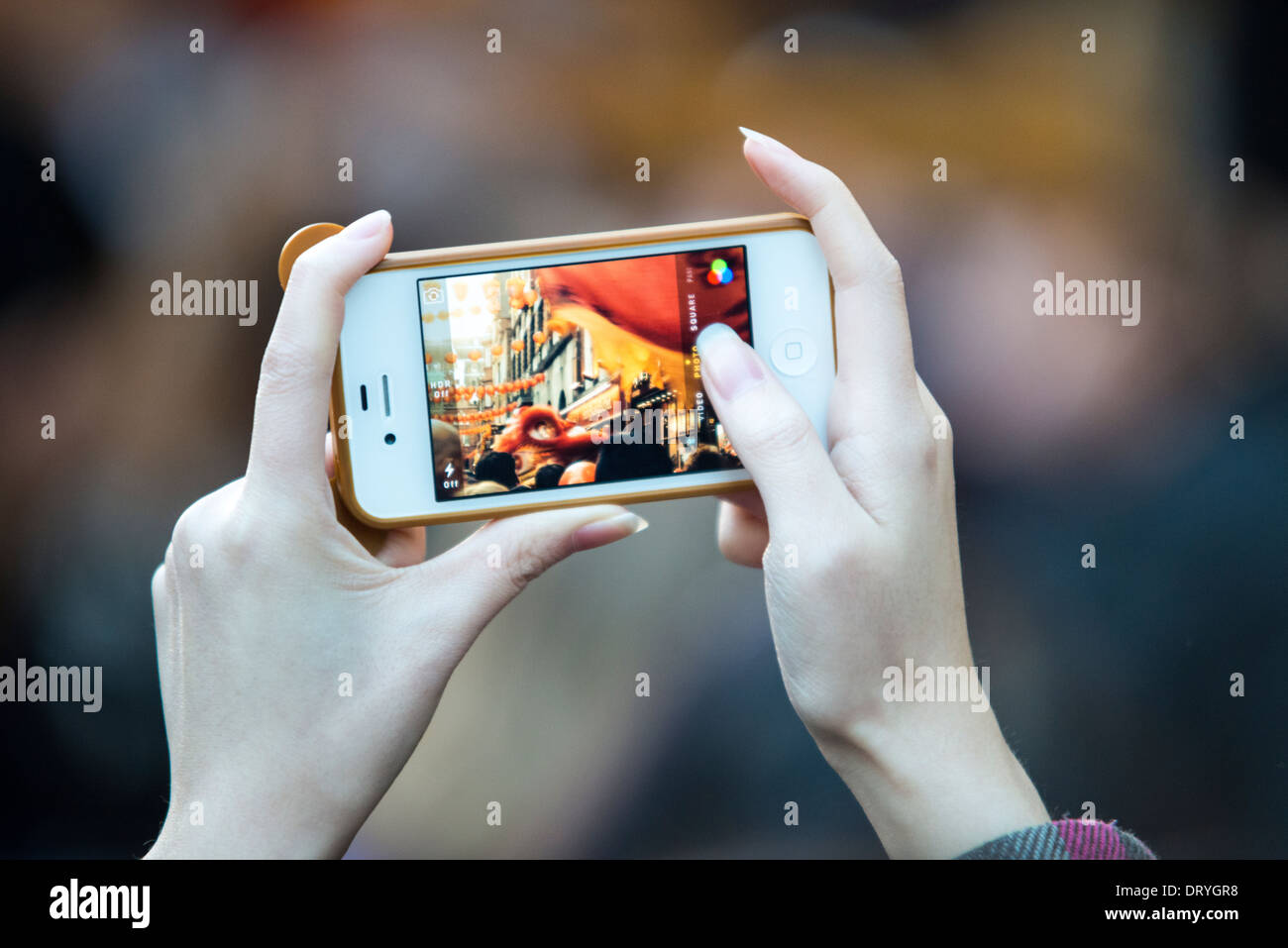 Girl takes photos on her mobile phone-close-up Stock Photo