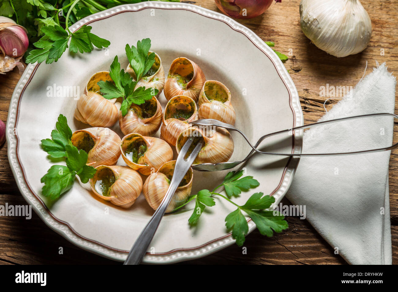 Eating the fried snails in garlic butter Stock Photo Alamy