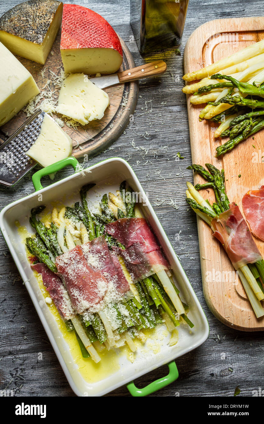 Asparagus wrapped in Parma ham with cheese Stock Photo Alamy